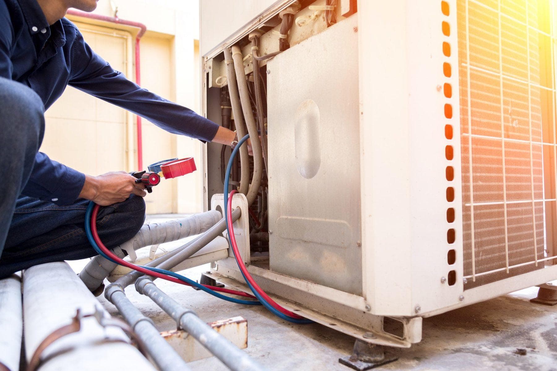Technician installing HVAC unit
